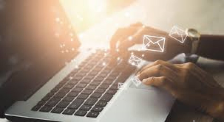 hands on a laptop with an email icon popping up from the keyboard